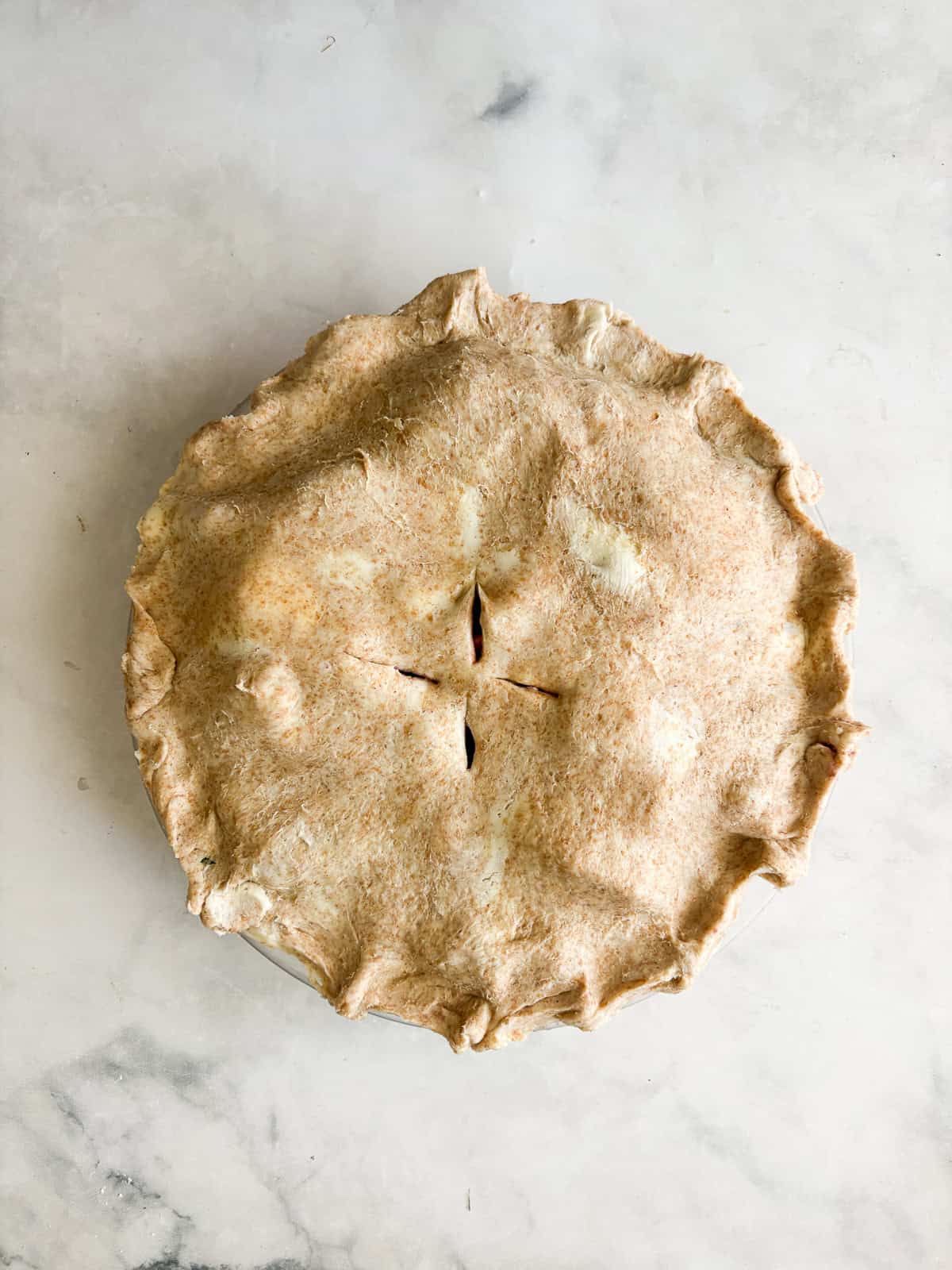 Juicy apples combine with sun-warmed blackberries in this apple blackberry pie. Choose a homemade, gluten-free, or store-bought pie crust. Crust is added to the top of a blackberry apple pie.