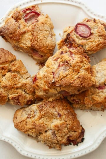 A white plate full of strawberry scones.