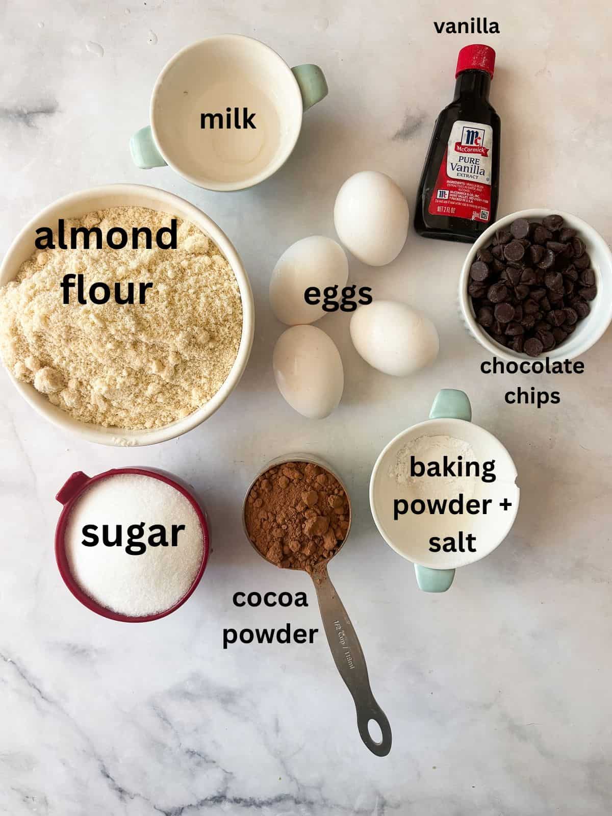This irresistible one bowl almond flour chocolate cake is wonderfully fluffy and rich, and you need just one simple flour to make it. Ingredients for almond flour chocolate cake are text-labeled.
