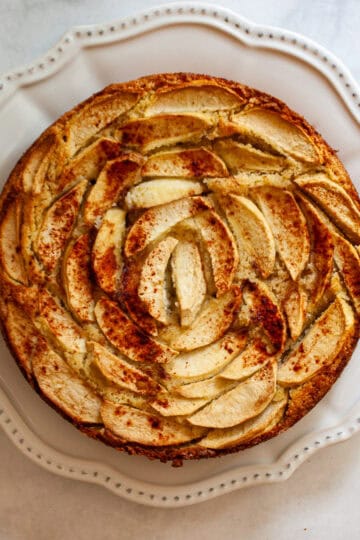 An almond flour apple cake on a plate.