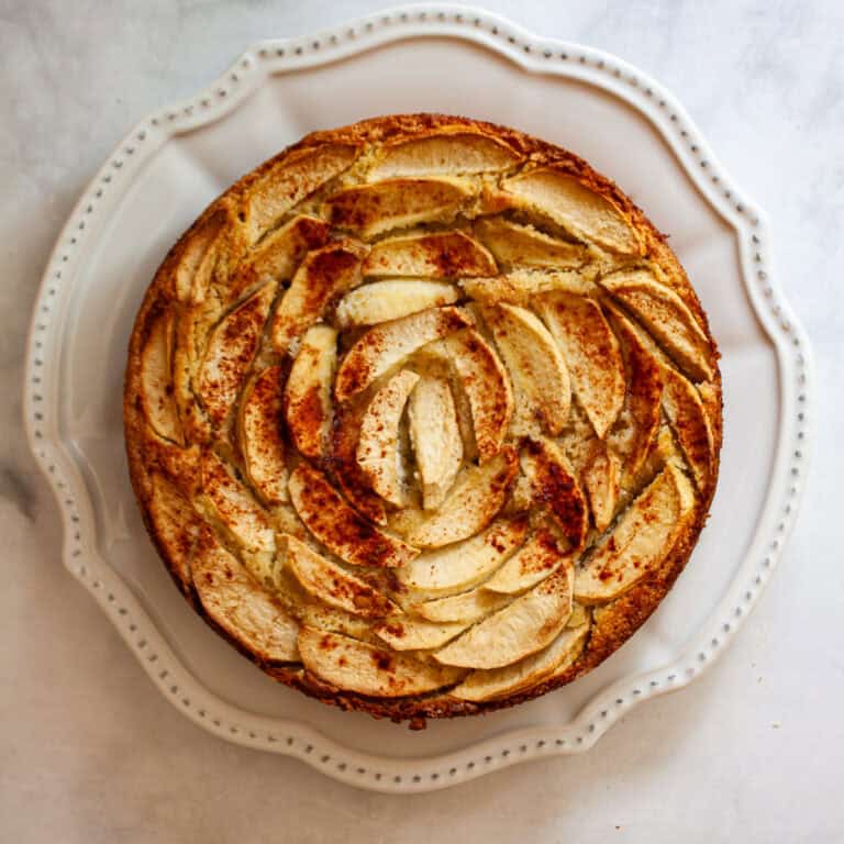 An almond flour apple cake on a plate.
