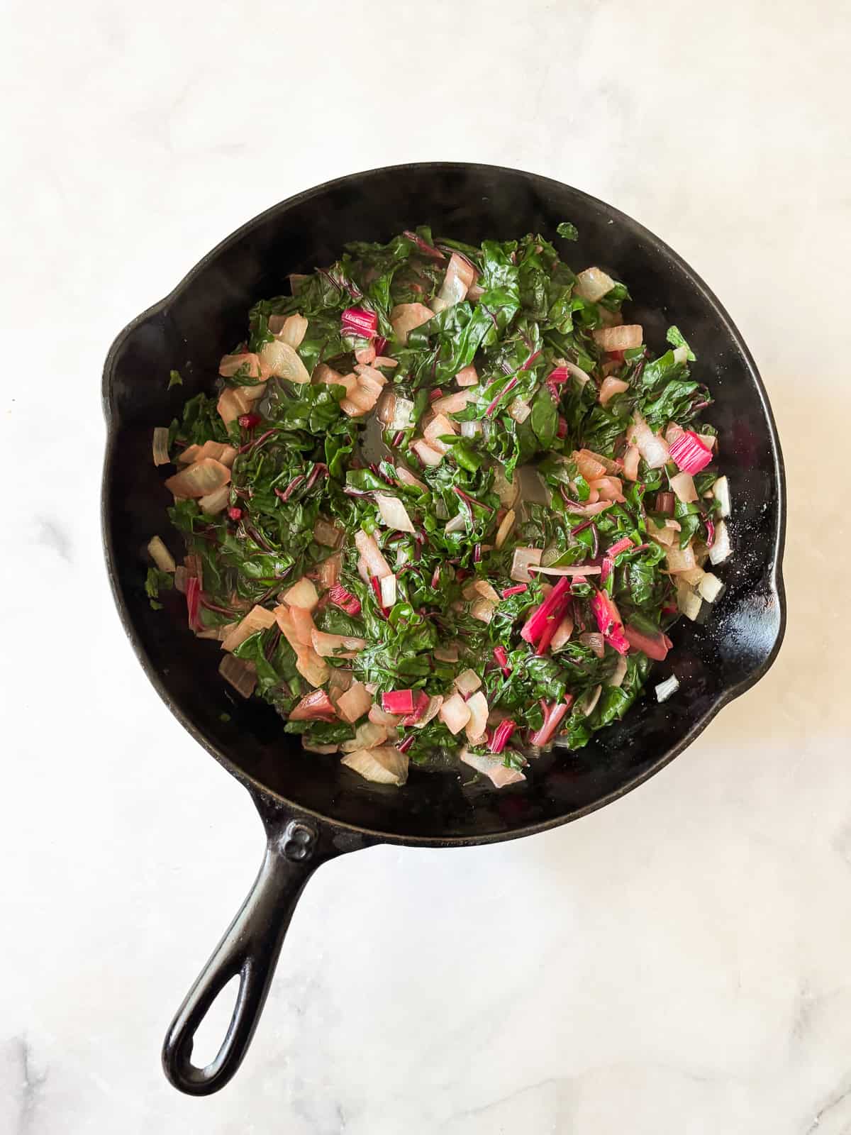 This easy chard gratin is a naturally gluten-free, vegetarian side dish made with fresh chard, onion, cheese, and milk. Perfect for fall and winter. Add the chard and cook until soft.
