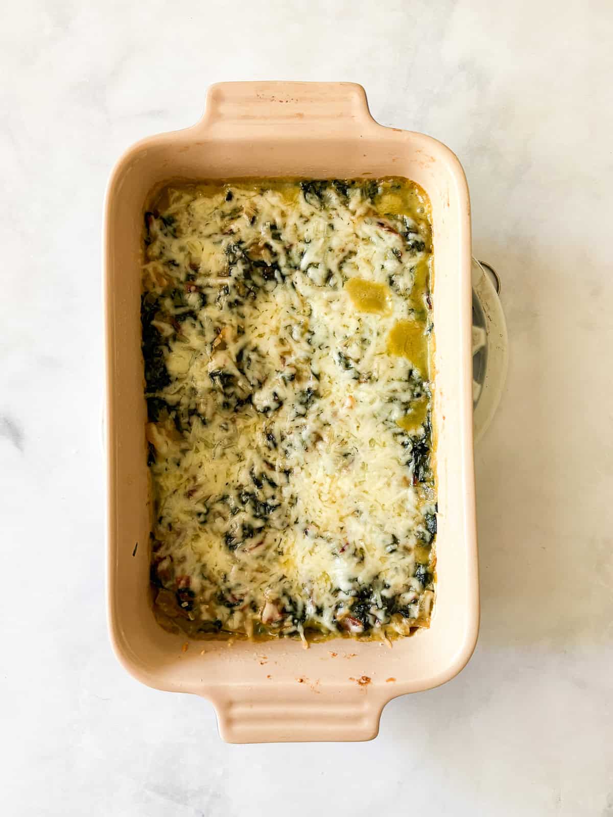 This easy chard gratin is a naturally gluten-free, vegetarian side dish made with fresh chard, onion, cheese, and milk. Perfect for fall and winter. Chard gratin after being baked.