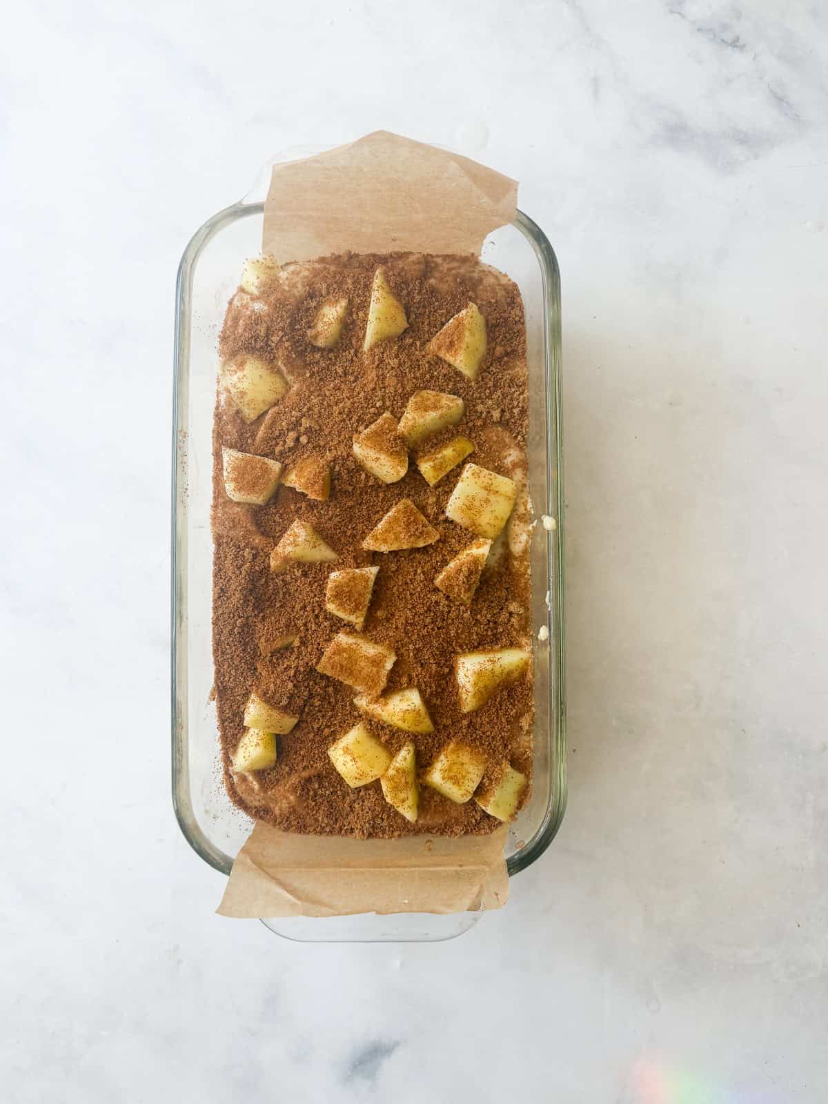 This gluten free apple bread is soft, buttery, and generously layered with fresh apples, cinnamon, and brown sugar. A one-bowl recipe! The final layer of apples and cinnamon sugar are added to the top of the gluten free apple bread batter.