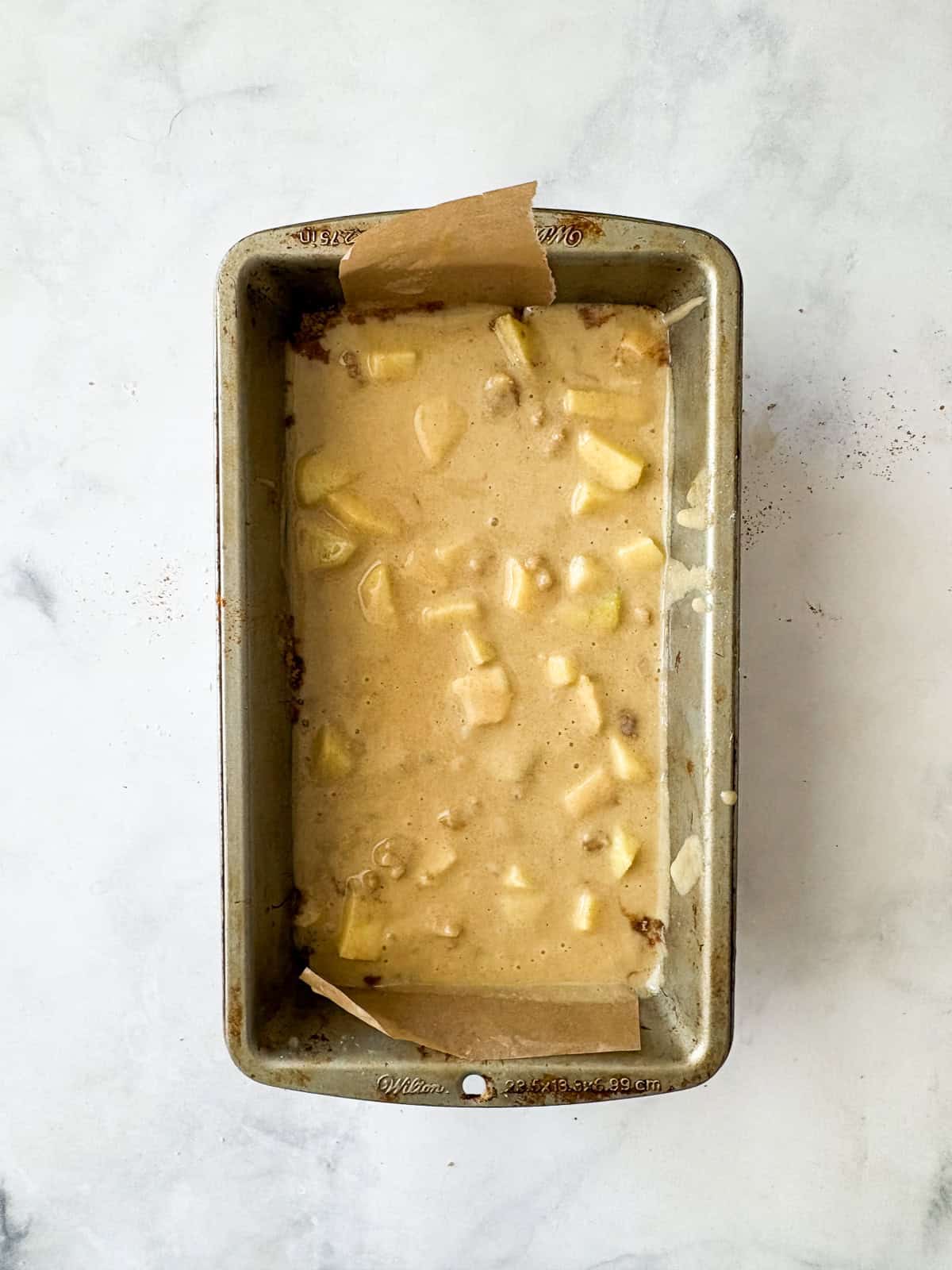 This easy apple walnut bread is tender and filled with fresh apples and crunchy walnuts. Make it with whole wheat flour or oat flour. Finish the batter for apple walnut bread in the pan.