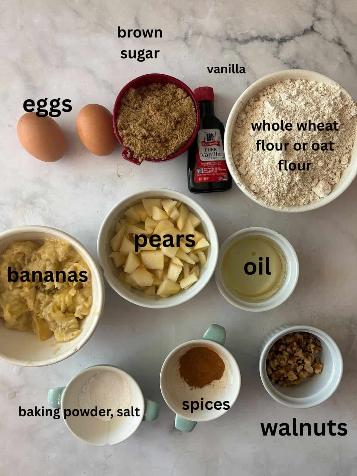 Easy banana pear bread made with whole wheat or gluten-free oat flour, juicy pears, and walnuts. A tender quick bread for fall and beyond. Ingredients for banana pear bread are text-labeled.