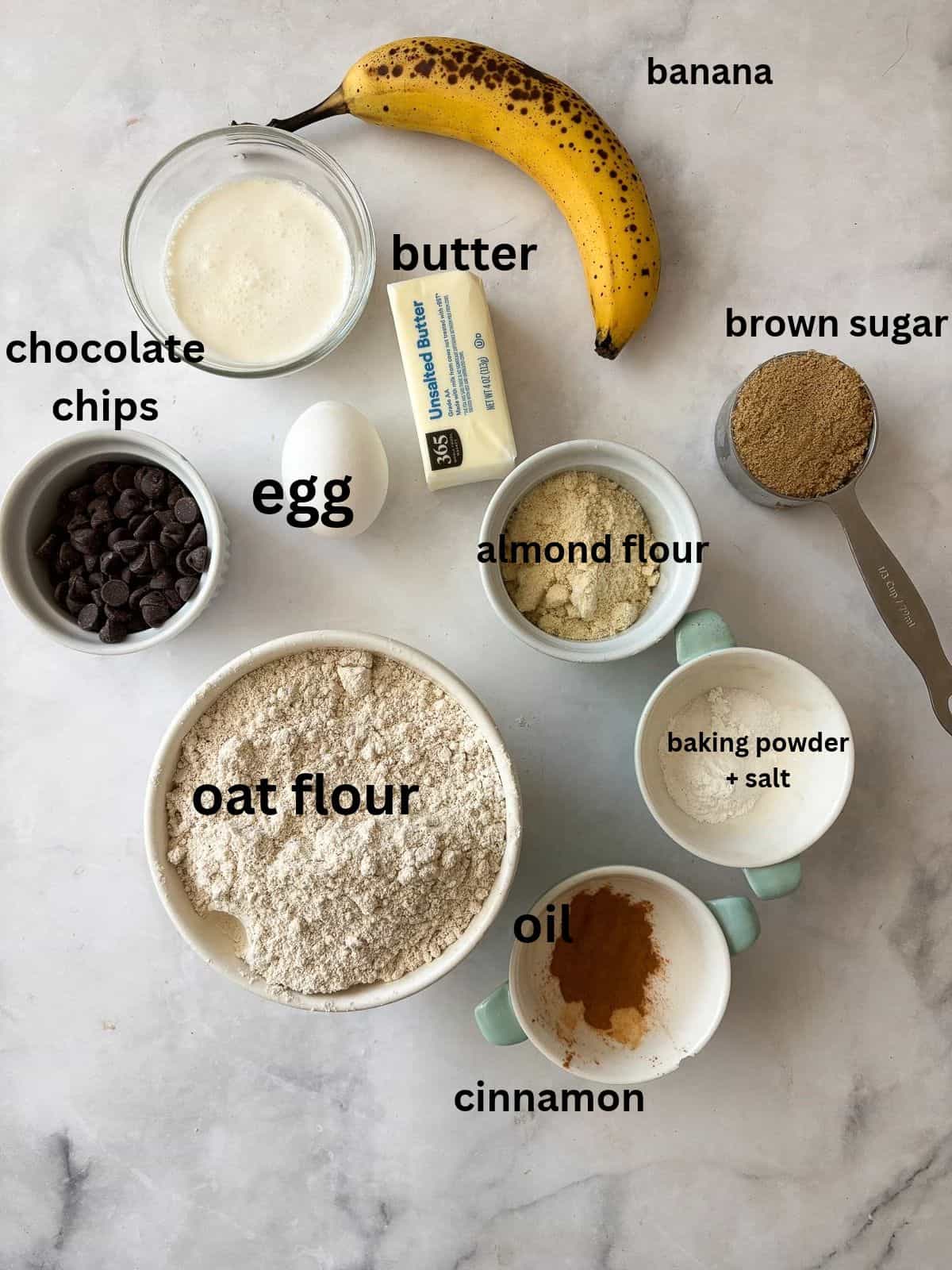 These whole grain banana scones are filled with chocolate chips, cinnamon, and a whole ripe banana for a tender, lightly sweet treat. Ingredients for chocolate chip banana scones are text-labeled.