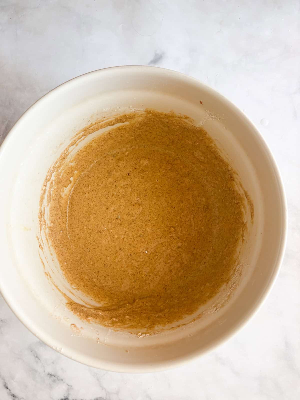Easy banana pear bread made with whole wheat or gluten-free oat flour, juicy pears, and walnuts. A tender quick bread for fall and beyond. Banana pear bread batter in a bowl.