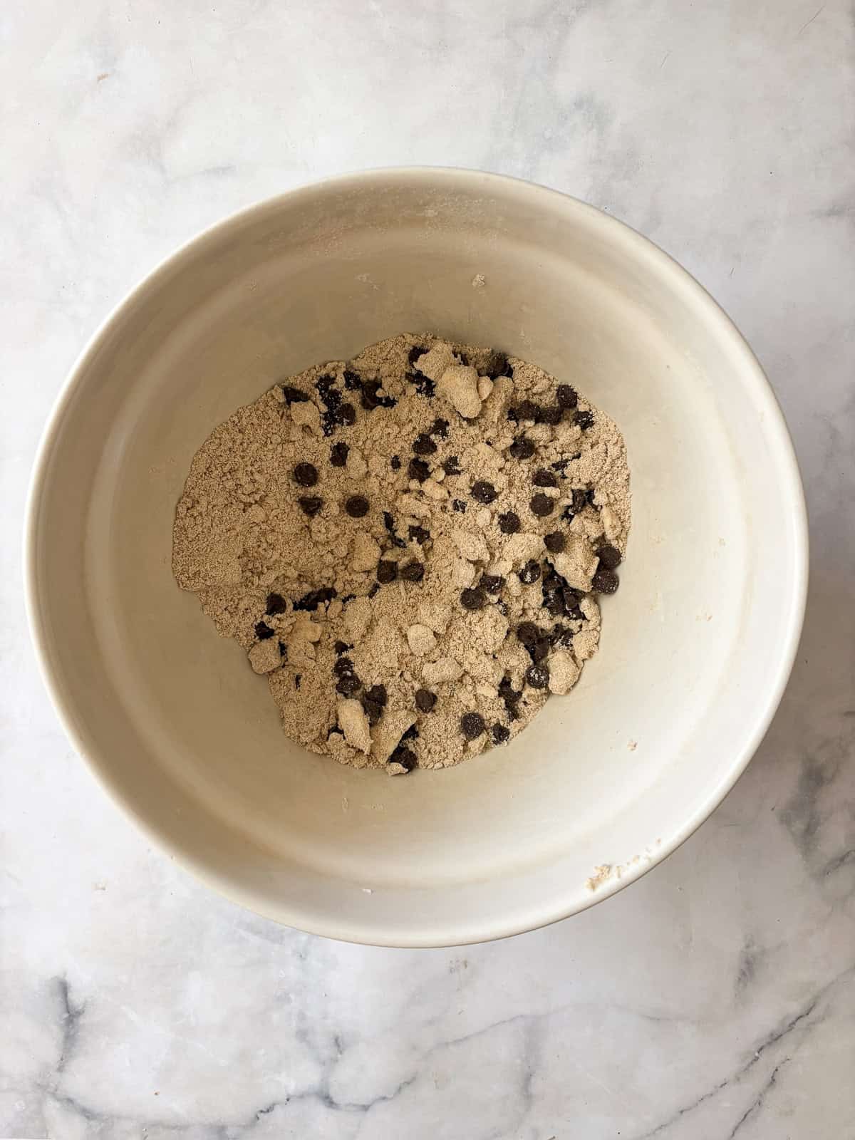 These whole grain banana scones are filled with chocolate chips, cinnamon, and a whole ripe banana for a tender, lightly sweet treat. Chocolate chips are added to banana scones dough.