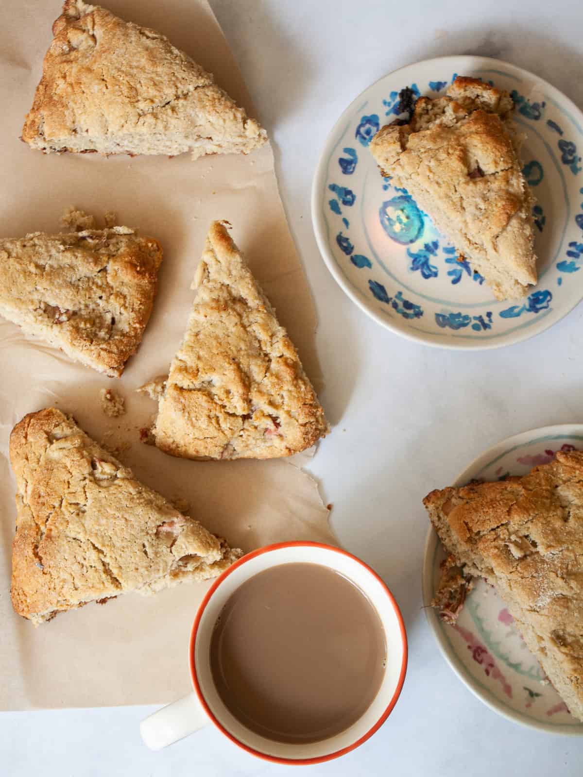 The simplest, tenderest gluten free oat flour scones that are made just with oat flour. Use this recipe as your base for all sorts of add-ins, from fruit, to chocolate, to maple syrup. Oat flour scones on parchment and plates.