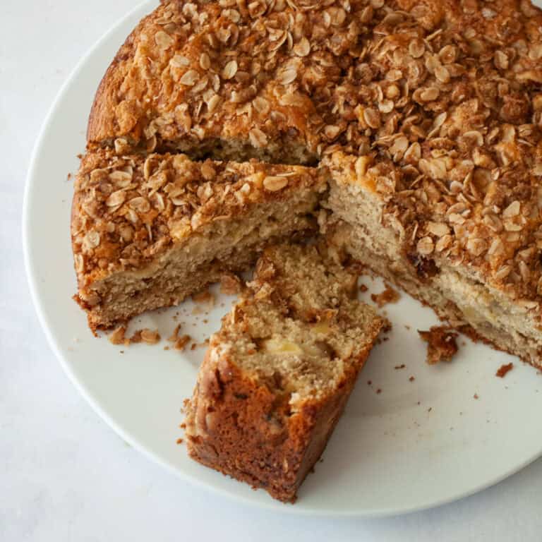 Slices of apple crumb cake on a serving plate.
