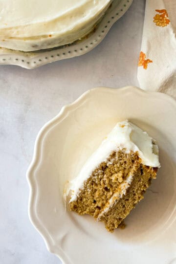 A slice of gluten free pumpkin layer cake on its side on a plate.