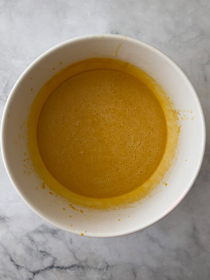 This gluten-free olive oil pumpkin bread is rich, moist, and full of fall spices. Made with oat and almond flours, it's easy to customize! Wet mix for olive oil pumpkin bread in a bowl.