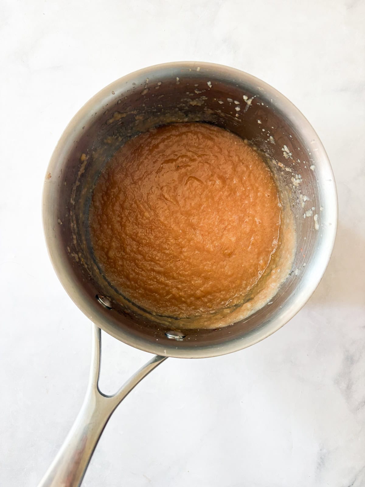 A smooth, sweet pear sauce that's best made with ripe pears! Add cinnamon and maple syrup if you like, or enjoy it plain. Pear smooth after cooking down in a pot.